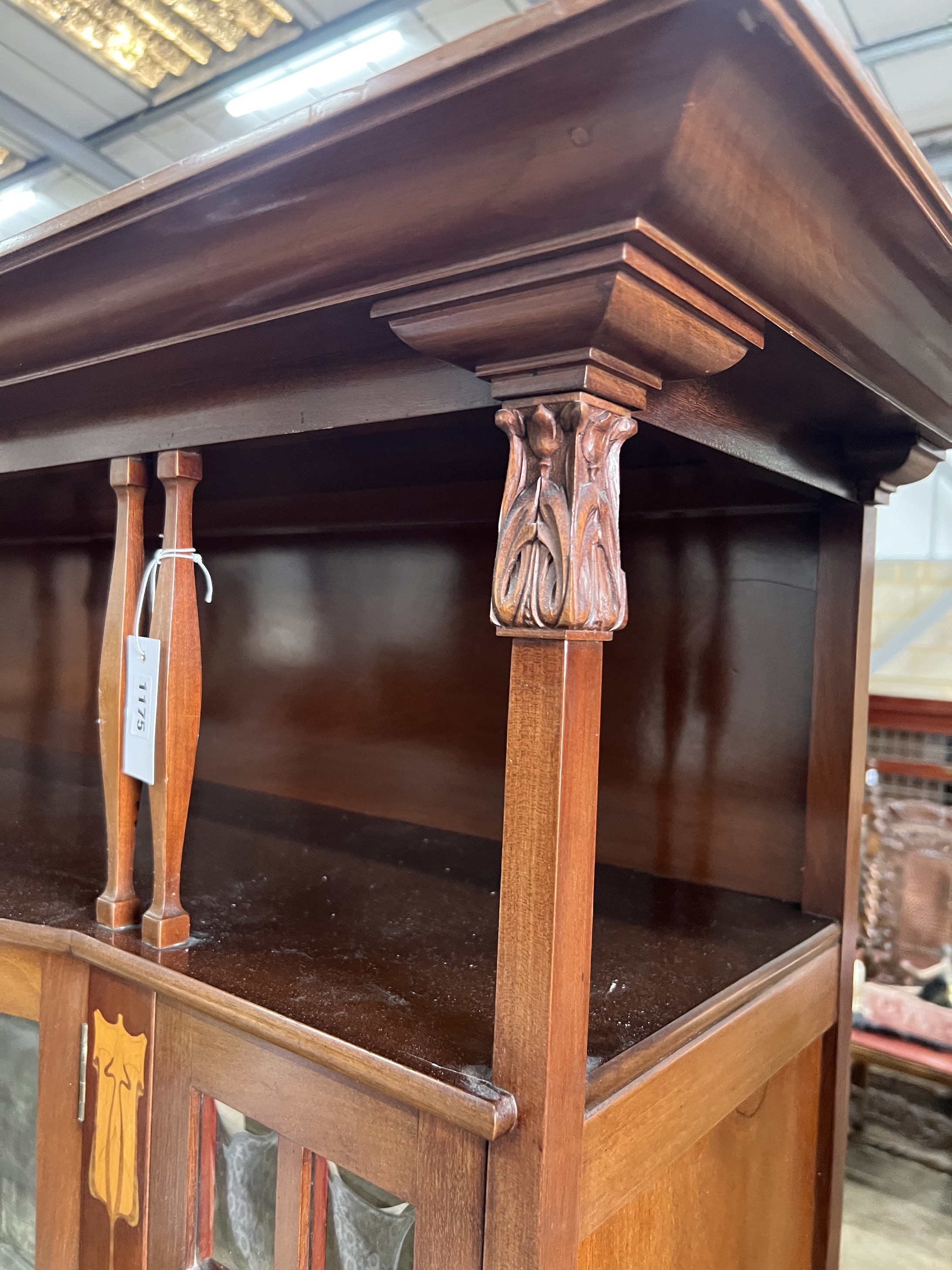 An Arts & Crafts marquetry inlaid mahogany bowfront display cabinet, width 157cm, depth 38cm, height 183cm